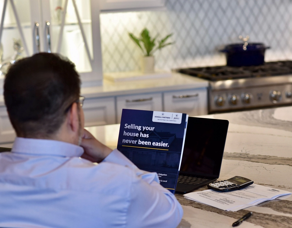 Homeowner reviewing home sale options and financial paperwork